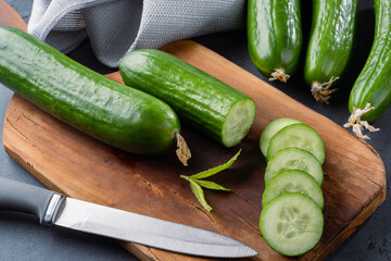 Fresh cucumber slices chopped on black  stone table