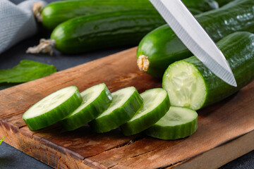 Fresh cucumber slices chopped on black  stone table