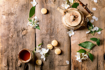 Tea pot cup white flowers wooden table