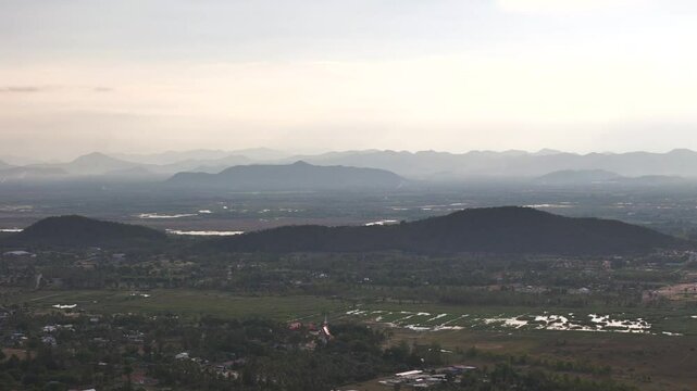 Beautiful panorama of light haze hilly Bueng Bua countryside with lakes in tropical landscape at sunset