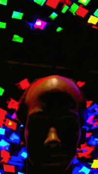 4K UHD Video of a Geometric Graphic Shapes Flashing in the Background of a Mysterious Figure