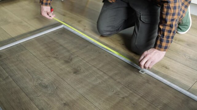 Caucasian man making a net for window to protect from mosquito