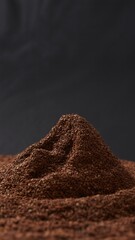 Aromatic Ground Coffee Beans forming a unique peak texture against a dark background