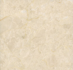 Fototapeta premium A beige marble surface with soft brown veining, smooth texture and refined natural patterns.