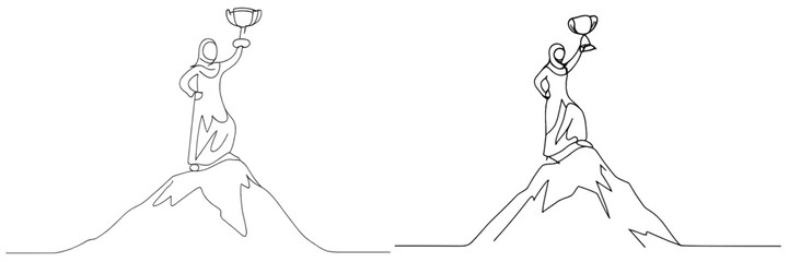 Fototapeta premium Victory celebration on a mountain peak with a trophy held high in the air during daylight hours