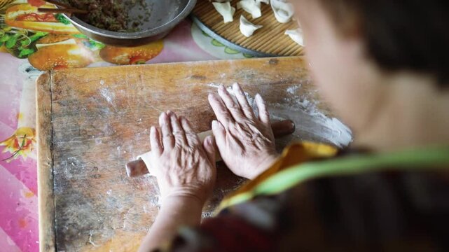 Making dumplings from scratch - squishing the dumpling dough to make the dumpling wrapper skins