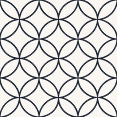 Fototapeta premium A seamless pattern of overlapping circles with a dark outline on a light background, creating a geometric design with a modern and minimalist aesthetic
