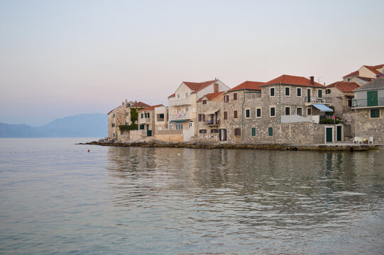 Traditional Dalmatian stone architecture, town Postira at sunset 