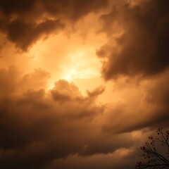 Obraz premium Dramatic clouds illuminated by sunset light with dark silhouettes