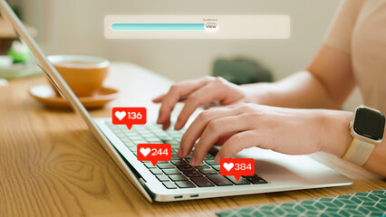 Social media marketing concept with an influencer's hands typing on a laptop as "like" and "view" notifications rapidly increase, symbolizing successful online engagement and viral content.