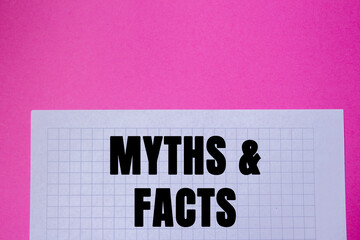Myths and facts message written on white paper on pink background. Conceptual myths and facts...