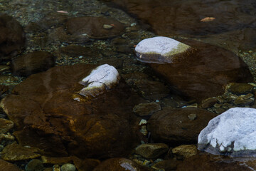 rocks and flowing water in the autumn valley