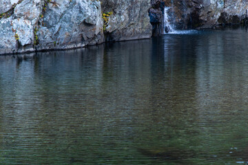 waterfall and flowing stream in the autumn valley