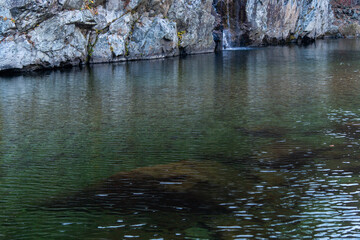 waterfall and flowing stream in the autumn valley