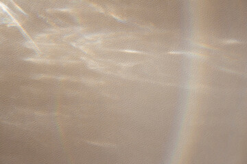 Editable template of soft pastel gradient colors with the effect of overlaying and refraction of blurred rainbow light on beige texture in the form of wavy lines for advertising,posters,mockup,photo.