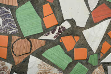 Colorful mosaic texture with various shapes and patterns. Includes green, orange, white, and brown...