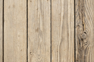 Wooden planks with a natural texture. The surface shows grain patterns and variations in color. Ideal for backgrounds or abstract designs.