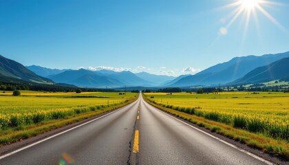 Naklejka premium capture a serene outdoor landscape with a straight asphalt street cutting through lush green fields, framed by majestic mountains under a clear blue sky