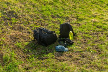 Two backpacks for photo cap and water bottle on the steps of the stairs