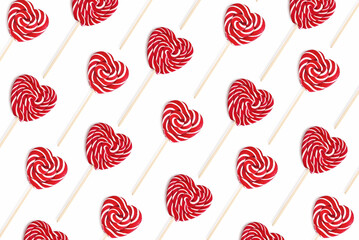 Pattern from heart lollipops candy on a stick