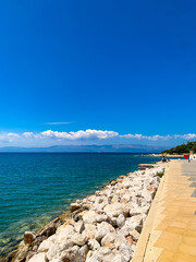 Fototapeta premium A small, lovely seaside town of Cesme along the beautiful coast with blue sea, sky and sunshine 