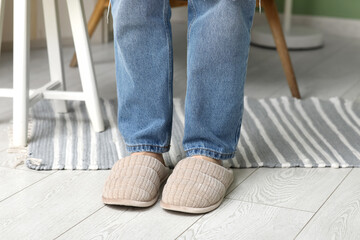 Female legs in stylish slippers in room, closeup