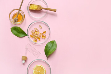 Petri dishes with samples and ingredients for preparing natural cosmetics on pink background