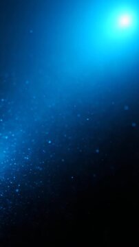 Blue particles moving in a blue light