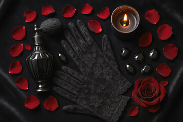 Dramatic flat-lay of black lace gloves, vintage perfume, dark candle, and red rose petals—capturing the essence of gothic romance and luxury beauty