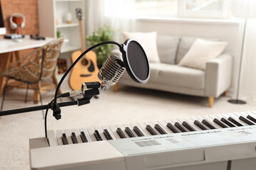 Stand with microphone and synthesizer in recording studio, closeup