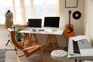 Interior of recording studio with workplace, mannequin and musical instruments