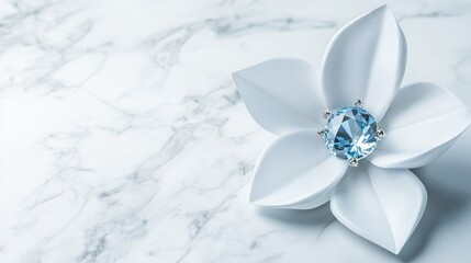Elegant white flower-shaped jewelry with a light blue gemstone on a marble surface.