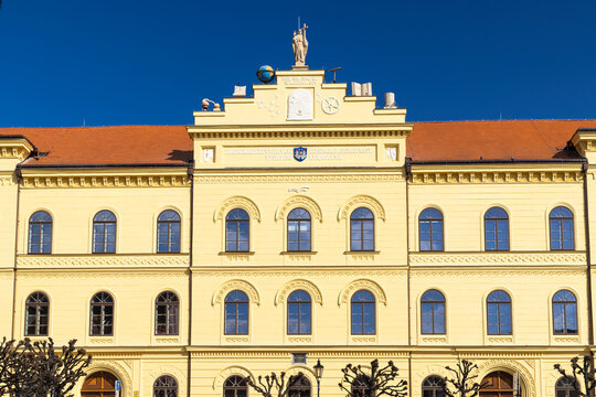 J. K. Tyl Theatre in Pisek showing its yellow facade and allegorical statues on a sunny day