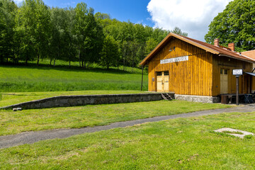 Zubrnice Train Station Building with Lush Green Grass and Trees in Czechia
