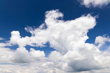 White cumulus clouds drifting across a vibrant blue sky in Loveckovice, Czechia