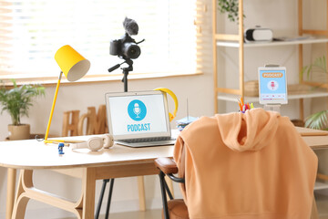 Podcaster's workplace with laptop and headphones in studio