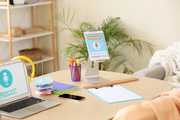 Podcaster's workplace with laptop and tablet computer in studio
