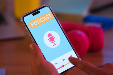 Male hands using mobile phone in dark podcaster's studio, closeup