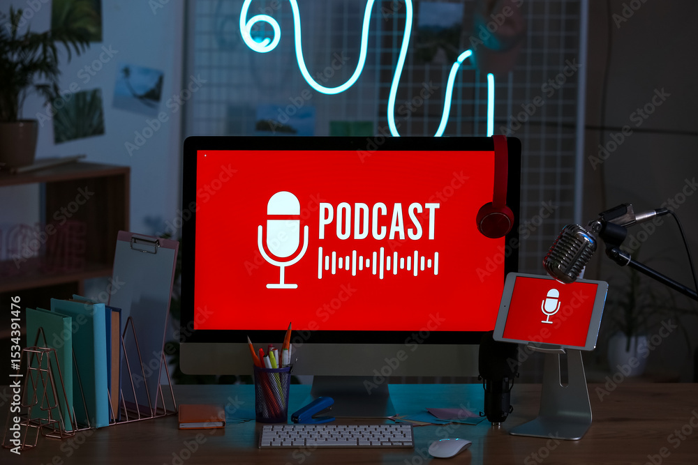 Poster podcaster's workplace with computer and glowing neon lamp in dark studio