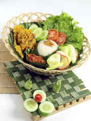 Indonesian culinary: Nasi Uduk Betawi. Coconut flavored steamed rice dish from Betawi with Ayam Kremes