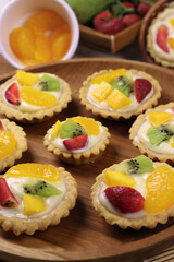 Fruit pie, Closeup of delicious pastry sweets pies colorful cakes with fresh  fruit on wooden dish