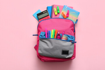 Obraz premium Stylish school backpack with different stationery supplies on pink background