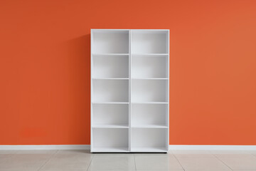 Empty white shelf unit near color wall in room