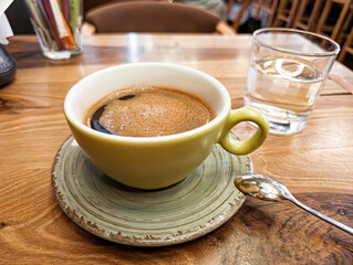 Green Coffee Cup on Wooden Cafe Table
