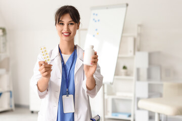 Female medical intern with pills in clinic