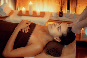 Caucasian woman enjoying relaxing anti-stress head massage and pampering facial beauty skin...