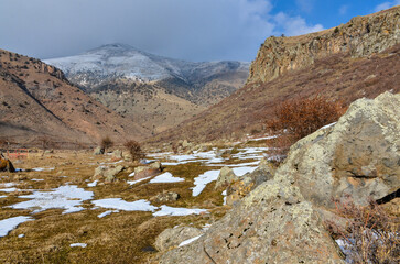 granite rocks and snow in Hrazdan river valley near Bjni village (Kotayk province, Armenia)	