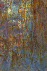 Rusty metal surface texture on outdoor wall with variety of shades and colors