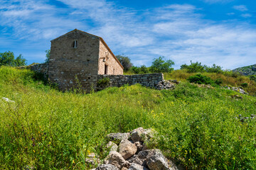 Old stone chapel on green Akrokorinthos hillside