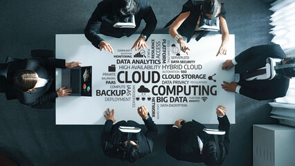 Aerial view of a business meeting discussing cloud computing, data management, and security strategies, showcasing teamwork and professionalism in a modern office setting. Amity